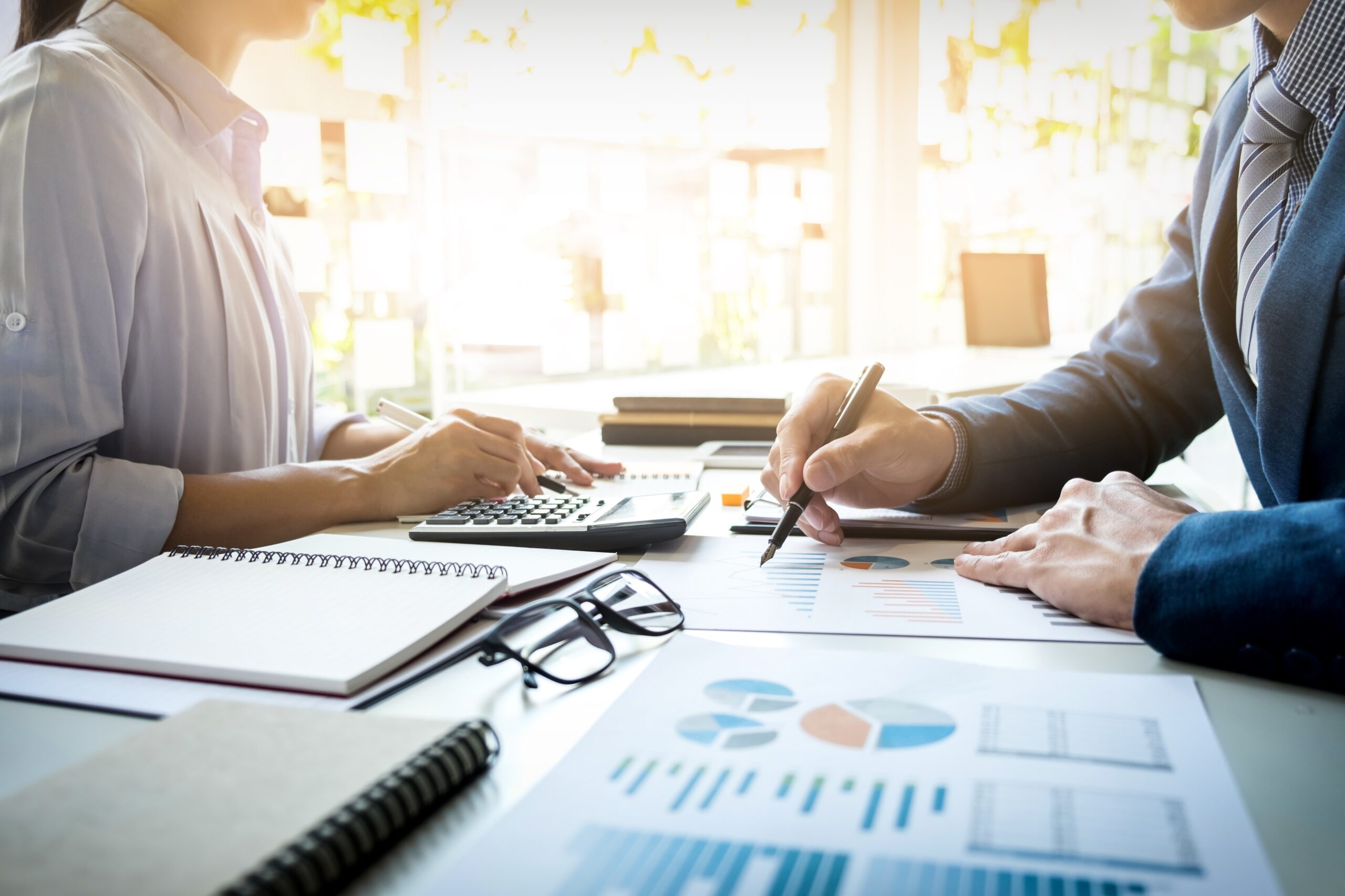 business man financial inspector and secretary making report, calculating or checking balance. Internal Revenue Service inspector checking document. Audit concept.